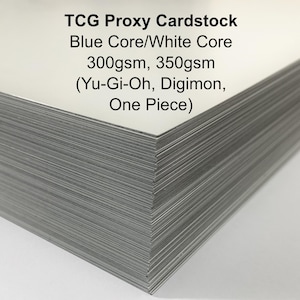 May include: A stack of TCG Proxy Cardstock with a blue core and white core. The cardstock is available in 300gsm and 350gsm weights. The text on the cardstock includes "Yu-Gi-Oh, Digimon, One Piece".