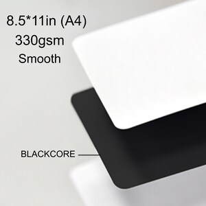 May include: A stack of smooth, white and black paper sheets. The top sheet is white, and the bottom sheet is black. The text on the image reads: 8.5*11in (A4), 330gsm, Smooth, and BLACKCORE.