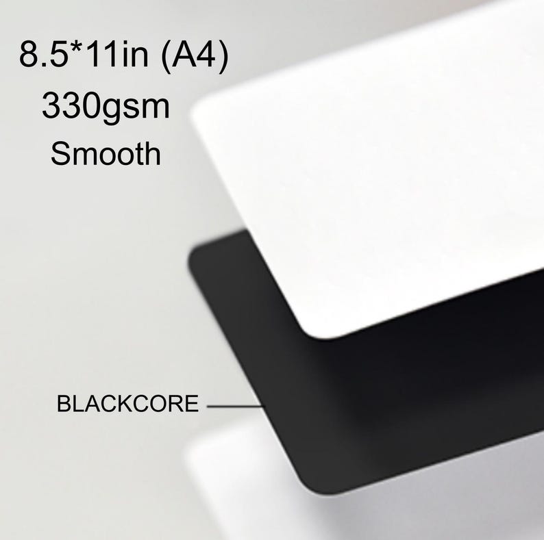 May include: A stack of smooth, white paper sheets with a black core, labeled as 21.6 x 27.9 cm (A4) and 330gsm. The text "BLACKCORE" is visible. The paper appears to be high-quality and suitable for various uses.