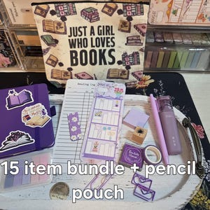 May include: A collection of stationery items, including a purple notebook with stickers, a pencil, and a pouch with the text "JUST A GIRL WHO LOVES BOOKS." The bundle includes a bookmark, sticky notes, and decorative tape. The text "15 item bundle + pencil pouch" is also visible.