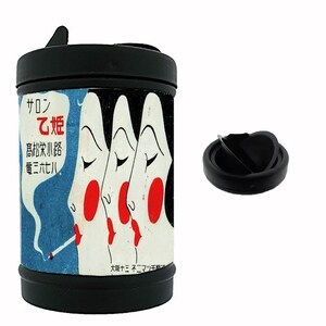 May include: A cylindrical black portable ashtray featuring a vintage-style graphic of three stylized faces with red cheeks and lips, one smoking a cigarette. The design includes Japanese text. A separate black lid with a central opening is shown.
