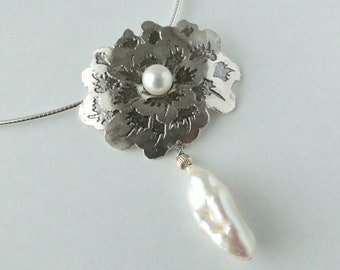 Flower patterned silver with pearl necklace.