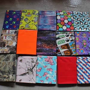 May include: A collection of 16 small, rectangular wallets made from colorful duct tape. Each wallet has a different design, including paw prints, owls, penguins, stars, and more.