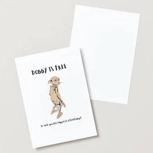 May include: White greeting card with the text "Dobby is Free" and an illustration of Dobby the house-elf. The card also includes the text "To wish you the happiest of birthdays!"
