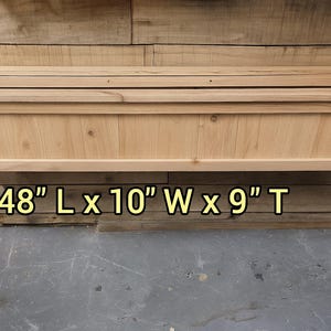 May include: A rectangular wooden planter box, 48 inches long, 10 inches wide, and 9 inches tall. The natural wood has a light color and visible grain. The planter is mounted on a wooden wall.