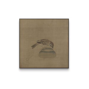 May include: A framed artwork featuring a detailed illustration of a sparrow perched on a small, round, blue-green vessel. The bird has brown and tan feathers. The background is a muted, earthy tone.