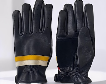 May include: A pair of black leather gloves with yellow and white stripes across the back of the hand. The gloves have small perforations for ventilation and a reinforced palm. The gloves are designed for protection and style.