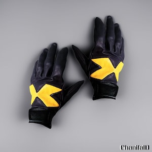 May include: A pair of black leather gloves with a yellow 'X' design on the back of the hand. The gloves have a wrist strap and are set against a gray background. The gloves are likely for cosplay or costume use.