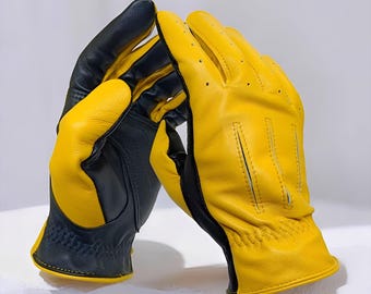 May include: A pair of yellow and black leather gloves. The gloves have a perforated design on the palm and fingers. The gloves are made of a soft, supple leather and have a classic design.