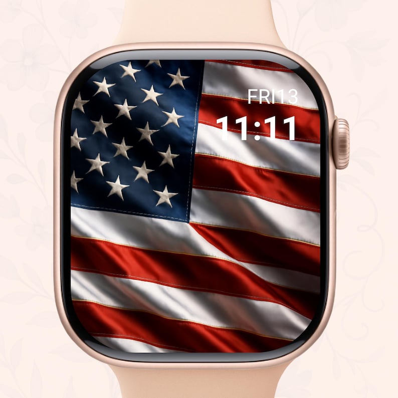 May include: A gold smartwatch with a display featuring the American flag. The watch face shows the date, Friday the 13th, and the time 11:11. The watch has a rounded rectangular face and a light pink band.