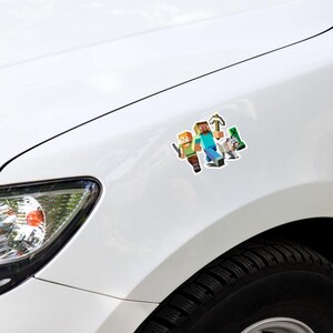 May include: A white car with a sticker featuring Minecraft characters. The sticker shows two figures, one with orange hair and a green shirt, and the other with brown hair and a blue shirt, along with a pickaxe, arrow, and a green creeper.