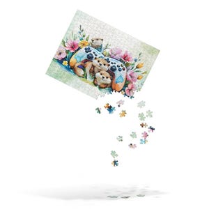 May include: A jigsaw puzzle featuring a watercolor illustration of otters gathered around a video game controller, surrounded by pink and yellow flowers. Some puzzle pieces are falling from the puzzle.