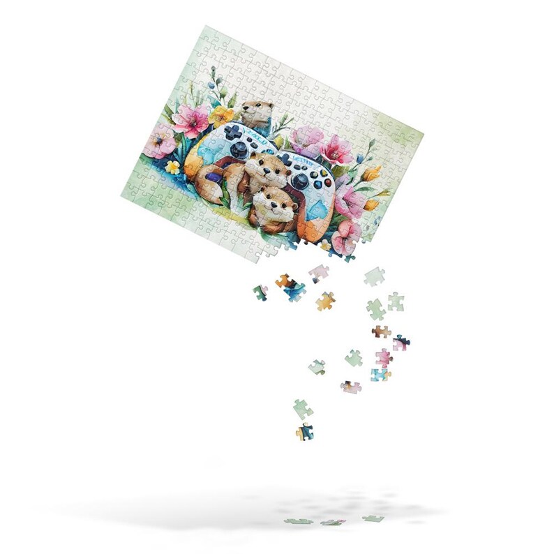 May include: A jigsaw puzzle featuring a watercolor illustration of otters gathered around a video game controller, surrounded by pink and yellow flowers. Some puzzle pieces are falling from the puzzle.