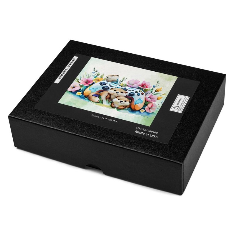 May include: A black puzzle box featuring a colorful illustration of otters, game controllers, and flowers. The puzzle image includes the text "Puzzle 11x14 252 Pcs". The box is made in the USA.