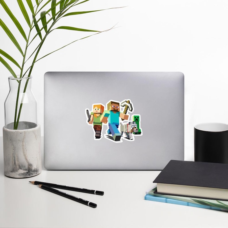 May include: A sticker featuring characters from the video game Minecraft. The sticker shows two human figures, a wolf, and a creeper. One figure holds a sword, and the other holds a pickaxe. The characters are in a running pose, with a white background.