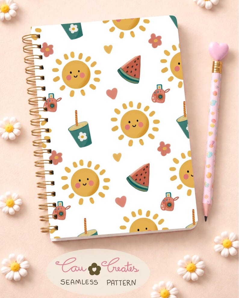 May include: A notebook with a summer pattern of smiling suns, watermelon slices, cameras, and drinks. It has a gold spiral binding and a pencil with a heart-shaped eraser. The text "Cau Creates" is visible. The notebook is surrounded by small white flowers.