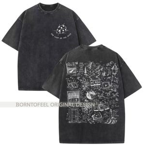 May include: Dark gray t-shirt with a distressed finish. The front features a ladybug graphic and the text "THE LAST OF THE BUGS." The back displays a detailed white graphic with various illustrations and text, including "AUG 31" and "4C-B3A."