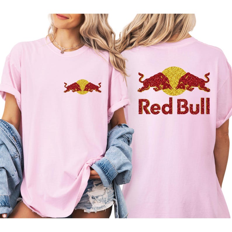 A woman wearing a pink t-shirt with a Red Bull logo and a denim jacket.
