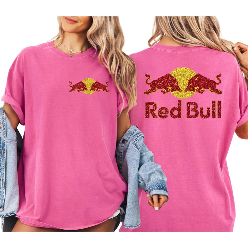 A woman wearing a pink t-shirt with the Red Bull logo and a denim jacket.