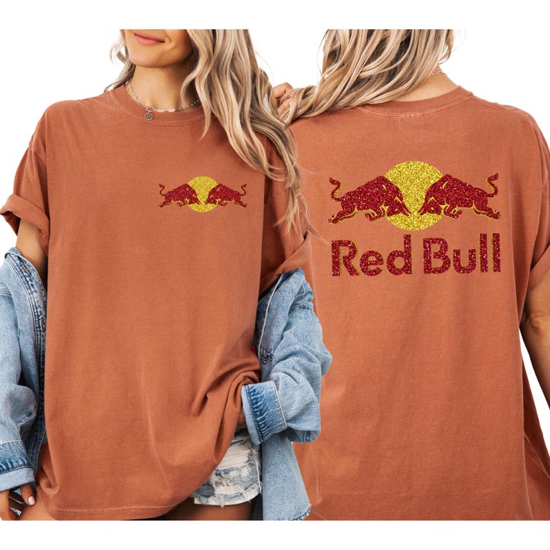 A woman wearing a red bull t-shirt with the Red Bull logo on the back.