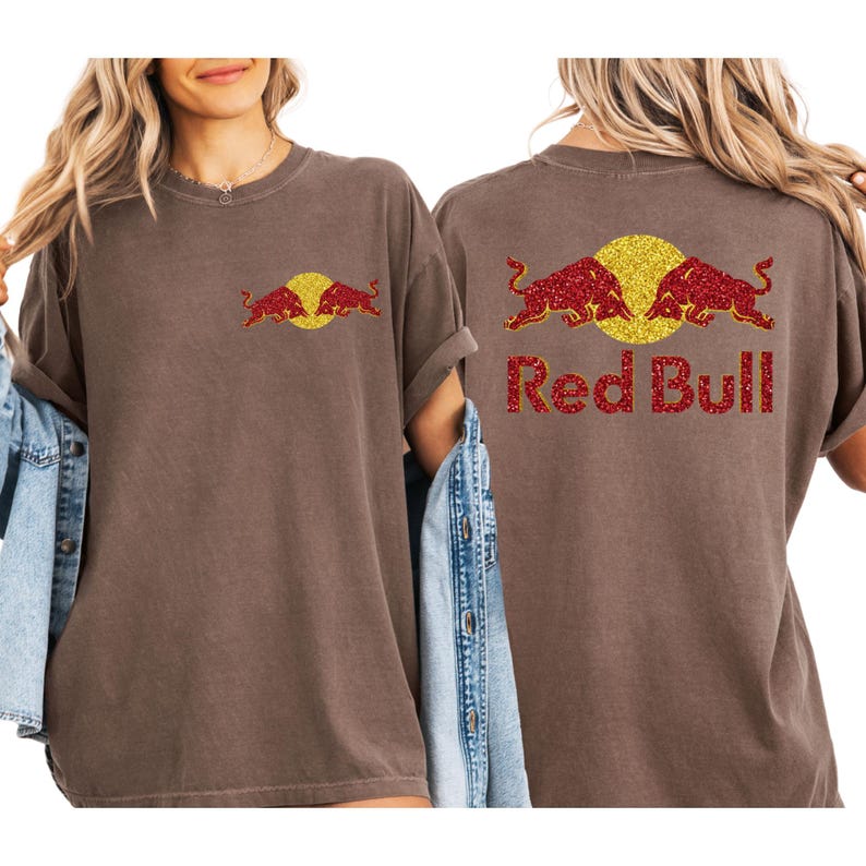 two women wearing brown t-shirts with the Red Bull logo on the back.