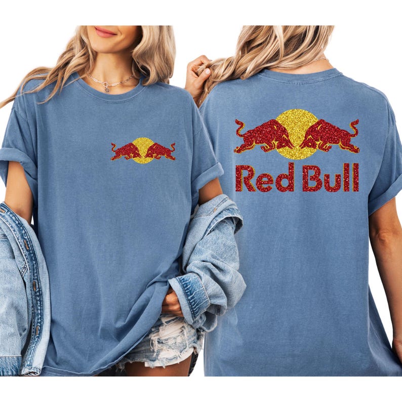 A woman wearing a blue t-shirt with a Red Bull logo and text on the back.