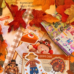 May include: A collection of autumn-themed paper ephemera including a Nostalgia Mail Club envelope, a Scholastic book list, a Thanksgiving recipe card, and stickers featuring a pumpkin pie slice, a turkey, and a scarecrow, accented by artificial fall leaves.
