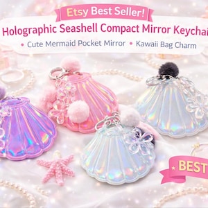 May include: Holographic seashell compact mirror keychains in purple, pink, and white. Each keychain features a seashell design with a fluffy pom-pom and a flower accent. The text reads "Etsy Best Seller!" and "Best Gift!"