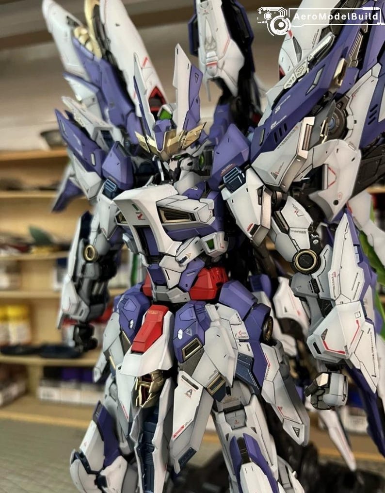 May include: A highly detailed mecha robot model, predominantly white, purple, red, and gold. The model features intricate mechanical detailing, large wings, and a futuristic design. The image highlights the model's complex construction and various components.