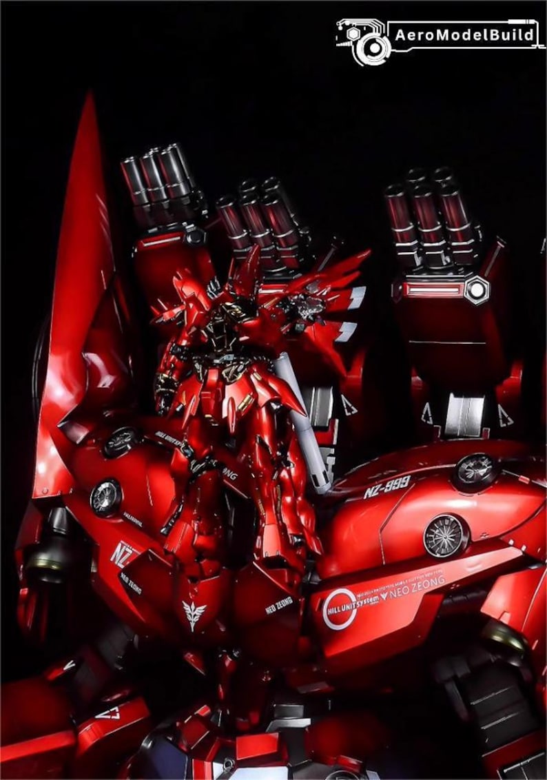 May include: A detailed, red model of a mecha robot, featuring intricate designs and multiple weapon systems. The model has a glossy finish and is set against a dark background. The text "NZ-999" and "Neo Zeong" are visible.