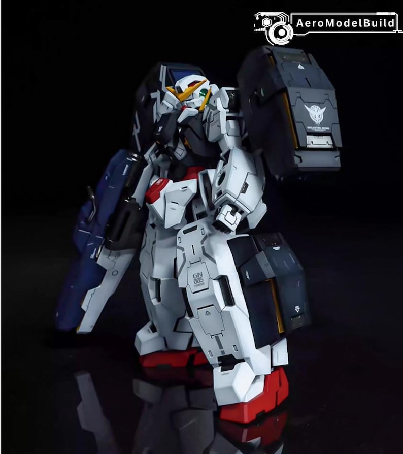 May include: A detailed model of a Gundam robot, primarily white with accents of red, blue, and black. The robot has a complex design with multiple panels and articulated joints. The image includes the text "AeroModelBuild".