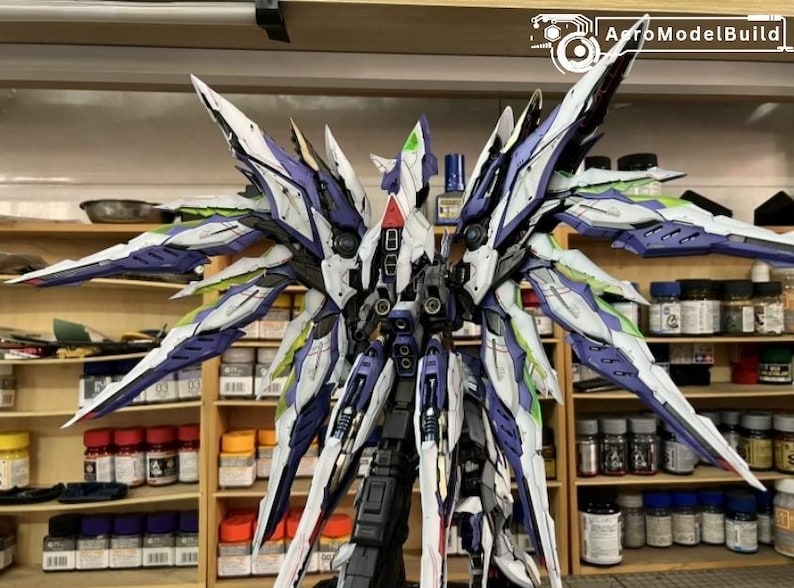 May include: A detailed model kit of a mech with large, stylized wings. The model features a colour scheme of white, purple, and green accents. The image includes the text "AutoModelBuild" in the upper right corner.