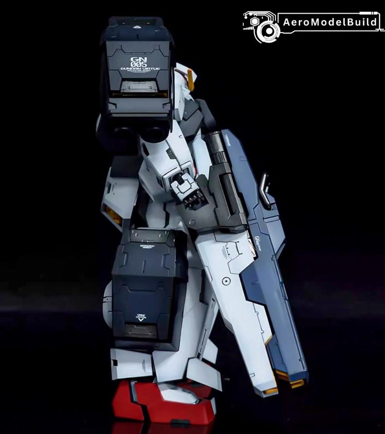 May include: A detailed model of a Gundam robot, featuring a color scheme of white, navy blue, and black. The robot has intricate panel lines and markings, with red accents on the feet. The image includes the text "GN 005 Gundam Virtue" and the logo "AeroModelBuild".