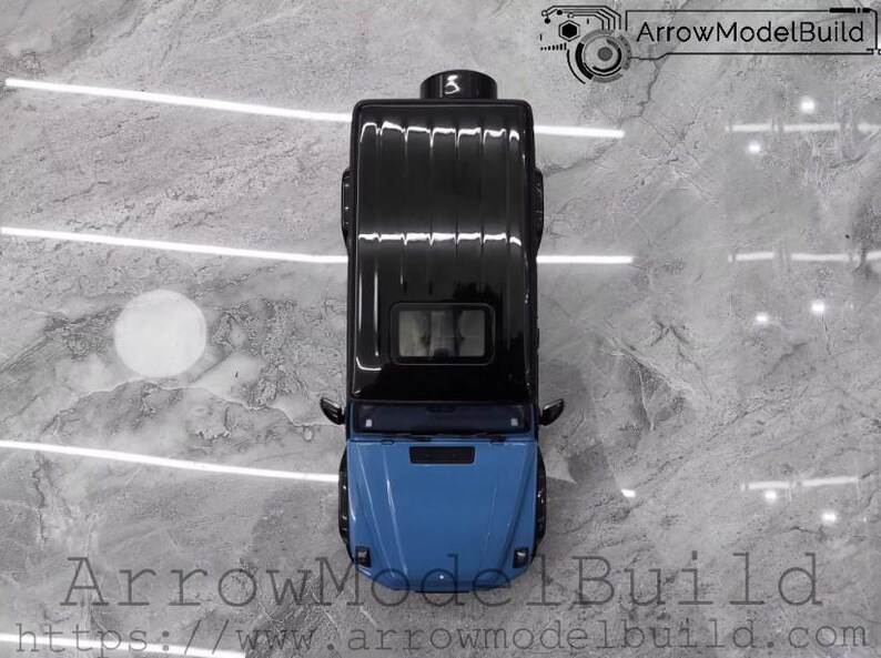 May include: Top-down view of a black and blue model car. The car has a black roof and a blue front. The image includes the text "ArrowModelBuild" and a website address.