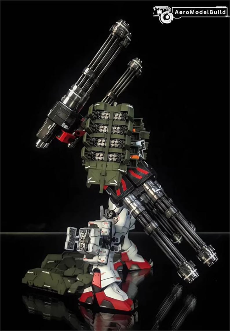 May include: A detailed model of a mech robot, with white, red, black, and olive green components. The robot has multiple large-caliber cannons and missile launchers, demonstrating a complex design. The AeroModelBuild logo is visible.