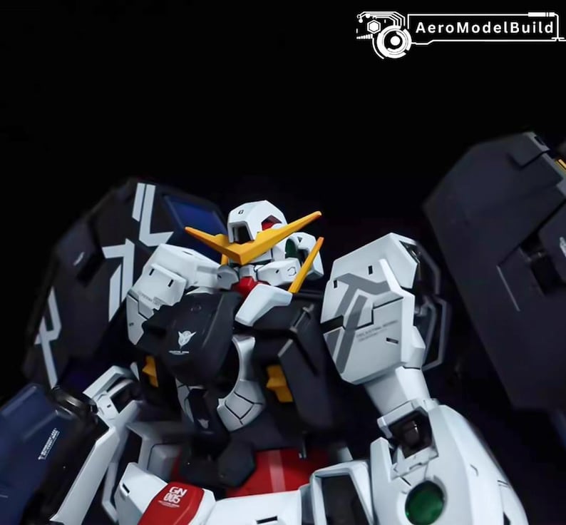 May include: A detailed close-up of a white, black, and red robot model. The model features intricate paneling, yellow accents, and a stylized head with a prominent crest. The text "AeroModelBuild" is visible in the top right corner.