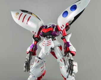 May include: A detailed model of a robot with white, red, and purple accents. The robot has large, wing-like structures on its back, and the text "ArrowModelBuild" is visible in the upper right corner. The robot's design features intricate details and a futuristic aesthetic.