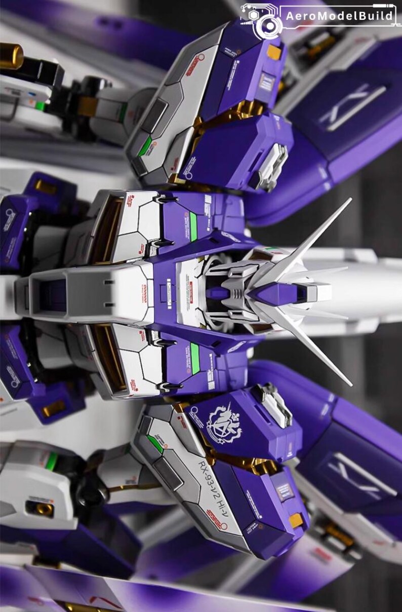 May include: A detailed model of a futuristic robot, primarily in shades of purple, white, and gray. The model features intricate mechanical details, sharp angles, and gold accents. The text "AeroModelBuild" is visible in the top right corner.