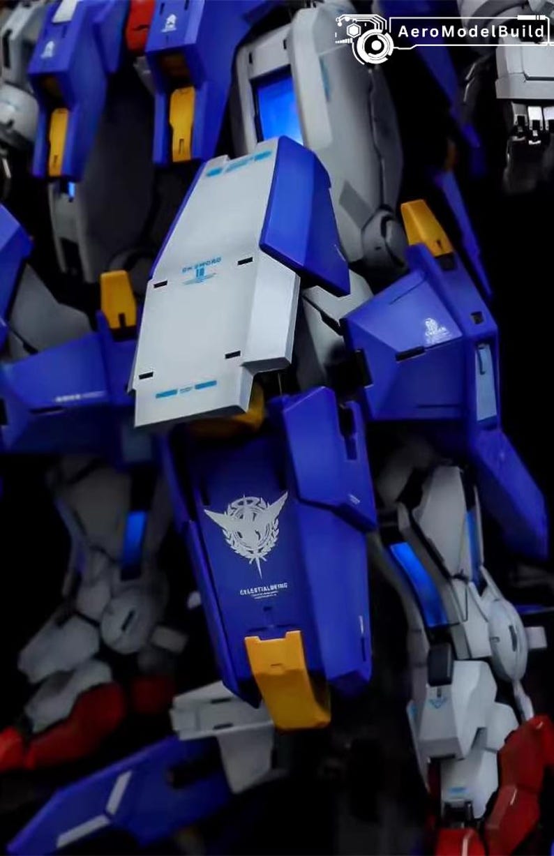 May include: Close-up of a detailed model kit of a robot, featuring a combination of blue, white, and yellow components. The model has intricate designs and the text "CELESTIALWING" is visible. The kit is likely for hobbyists and collectors.