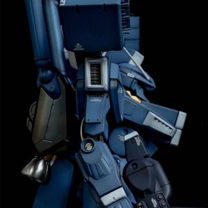 May include: A detailed, dark blue model of a robotic figure, featuring intricate mechanical components and paneling. The model has a metallic sheen and is set against a black background. The text "AeroModelBuild" is visible in the upper right corner.