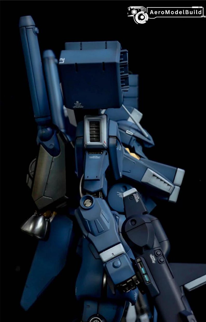 May include: A detailed, dark blue model of a robotic figure, featuring intricate mechanical components and paneling. The model has a metallic sheen and is set against a black background. The text "AeroModelBuild" is visible in the upper right corner.