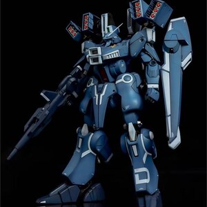 May include: A detailed model of a blue and white mecha robot with multiple missile launchers and a shield. The robot has intricate panel lines and is posed against a black background. The AeroModelBuild logo is in the top right corner.