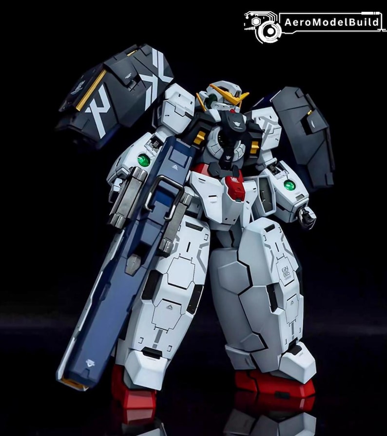 May include: A detailed model of a white, blue, and black robot with a large gun. The robot has articulated joints, angular armor plating, and red accents on its feet. The model has a futuristic design, with the AeroModelBuild logo in the top right corner.