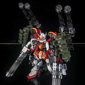 K&ouml;nnte beinhalten: Ein hochdetailliertes Gundam-Modell in Wei&szlig;, Rot und Orange mit olivgr&uuml;nen Raketenwerfern. Die Figur ist mit vier gro&szlig;en schwarzen Gatling-Kanonen ausgestattet, die an den Schultern montiert und in den H&auml;nden gehalten werden, vor einem schwarzen Hintergrund mit dem Text AeroModelBuild in der oberen rechten Ecke.