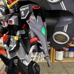 May include: A detailed model of a robot with a black, gray, red, and yellow color scheme. The robot has a large shield and the word "DESTROY" is visible on its shoulder. The model is highly detailed and appears to be a collectible item.