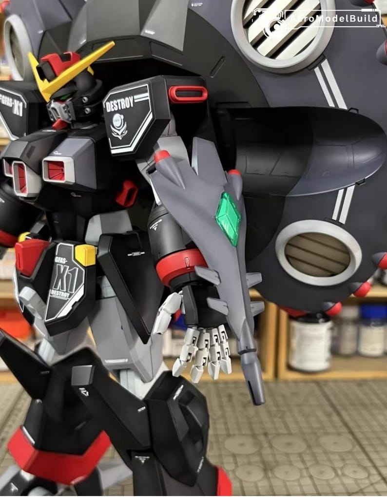 May include: A detailed model of a robot with a black, gray, red, and yellow color scheme. The robot has a large shield and the word "DESTROY" is visible on its shoulder. The model is highly detailed and appears to be a collectible item.