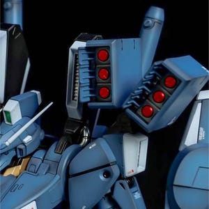 May include: Close-up of a detailed blue model with red missile details. The model features multiple sections, including a missile launcher with six red missiles. The model has the text "AeroModelBuild" in the upper right corner.