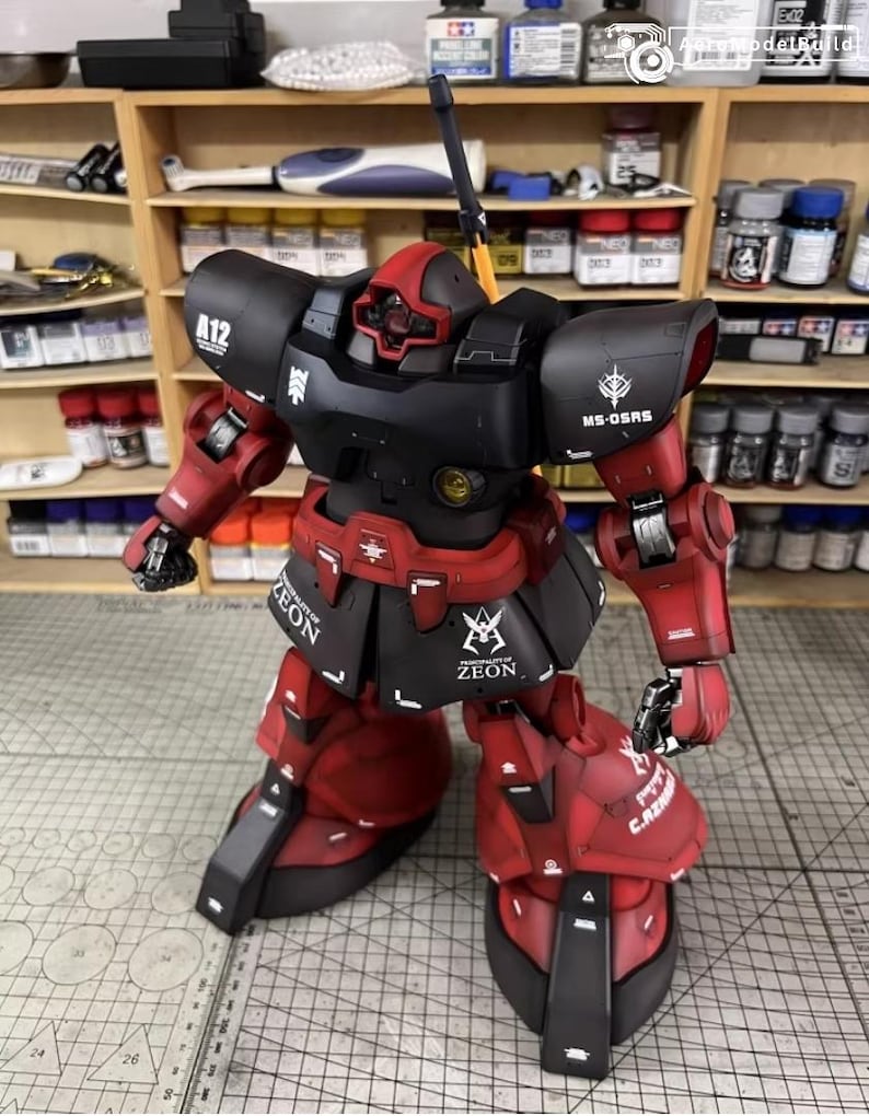 May include: A detailed model of a red and black robot with the text "ZEON" and "MS-OSRS". The robot has a red head and arms, with black armor and accents. The model is posed in a dynamic stance, showcasing its intricate design.