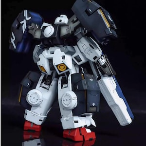 May include: A detailed model of a robot with a white, navy blue, and black color scheme. The model has intricate mechanical details, including articulated limbs, shields, and yellow accents. The robot's feet are red, and the model is set against a dark background.