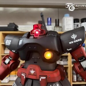 May include: A detailed model of a black and red robot with illuminated red and yellow lights. The robot has the text "A12" and "MS-OSRS" on its body. The AeroModelBuild logo is visible in the top right corner.